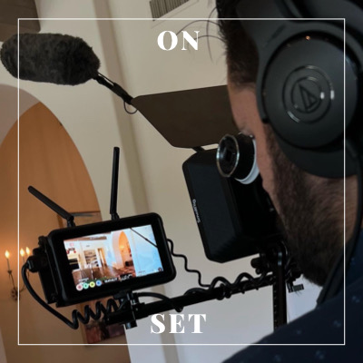 Photo of a man filming a scene.,