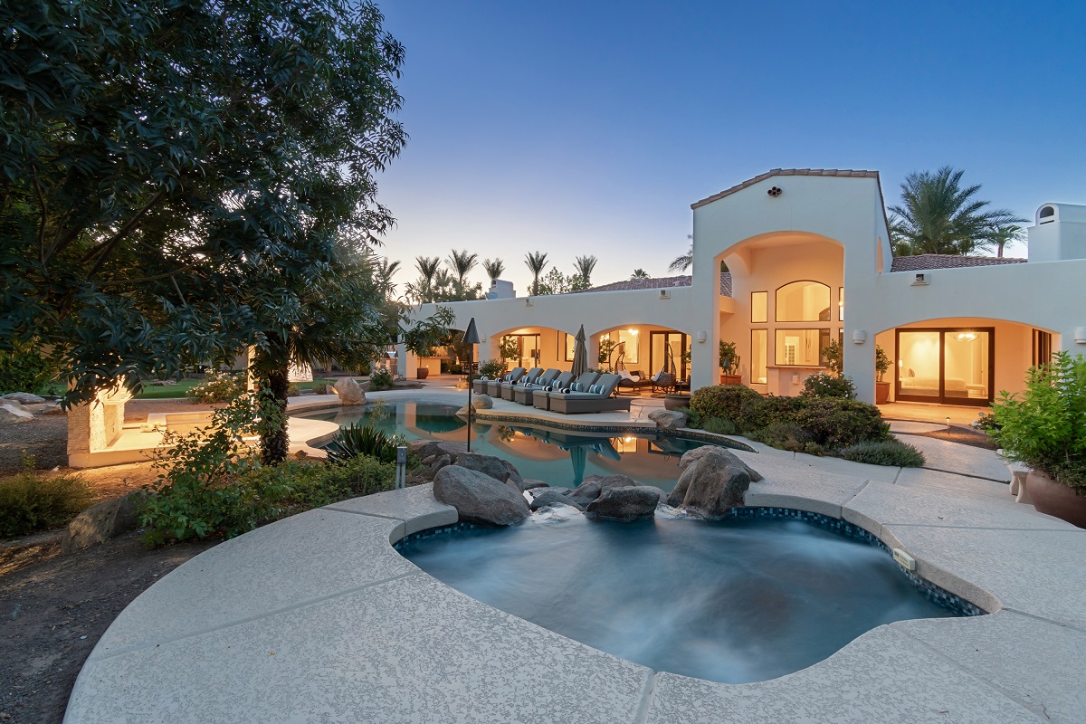 Photo of a pool and a house.