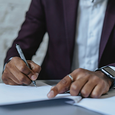 A man signing a letter.