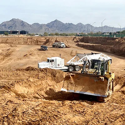 A tractor begins construction at Optima McDowell Mountain Village.